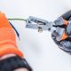 electrician stripping/crimping a green wire